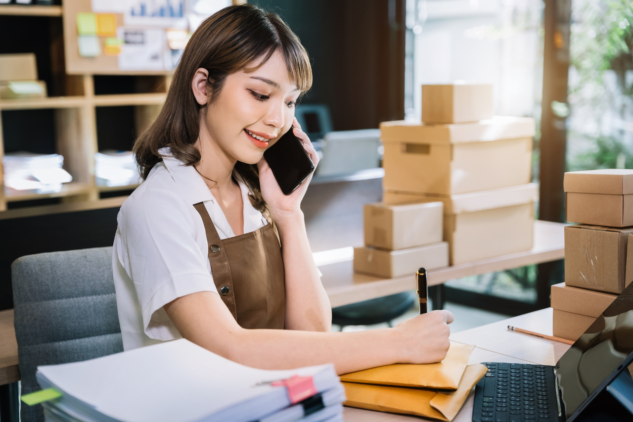 young asian women using smartphone contacted a customer asking f